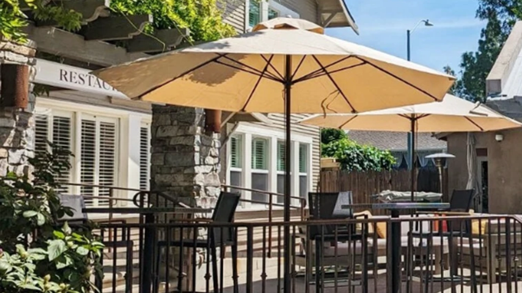 Commercial fabric contract umbrellas arranged on a restaurant patio